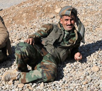 A Peshmerga soldier takes a break during urban operations training near Erbil, Iraq. Dutch and Norwegian soldiers, part of the Kurdistan Training Coordination Center, oversaw the day's training which included individual movement techniques, counter IED and entry control point procedures. The KTCC is a multi-national coalition dedicated to the training, advising and assistance of Kurdish forces to defeat ISIL in Iraq.