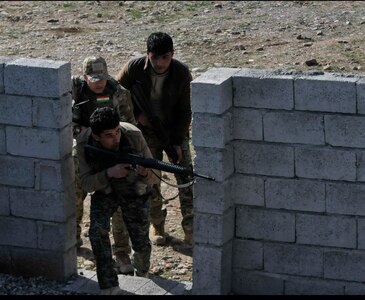 Peshmerga soldiers prepare to enter a building during urban operations training near Erbil, Iraq. Dutch and Norwegian soldiers, part of the Kurdistan Training Coordination Center, oversaw the day's training which included individual movement techniques, counter IED and entry control point procedures. The KTCC is a multi-national coalition dedicated to the training, advising and assistance of Kurdish forces to defeat ISIL in Iraq.