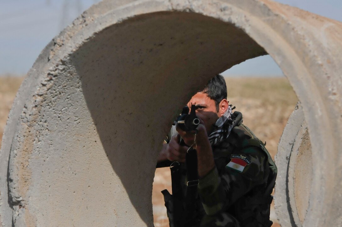 A Peshmerga soldier prepares for a counterattack during urban operations training near Erbil, Iraq. The Dutch, part of the Kurdistan Training Coordination Center, oversaw the day's training, which included individual movement techniques, counter IED and entry control point procedures. The KTCC works with Combined Joint Task Force – Operation Inherent Resolve building partner capacity as a global coalition dedicated to the training, advising and assistance of Kurdish forces to defeat ISIL in Iraq.