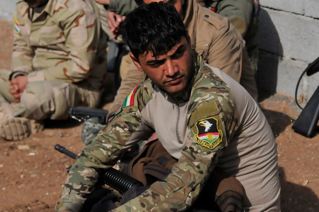 A Peshmerga soldier listens to after action review comments during urban operations training near Erbil, Iraq. Dutch and Norwegian soldiers, part of the Kurdistan Training Coordination Center, oversaw the day's training which included individual movement techniques, counter IED and entry control point procedures. The KTCC is a multi-national coalition dedicated to the training, advising and assistance of Kurdish forces to defeat ISIL in Iraq.