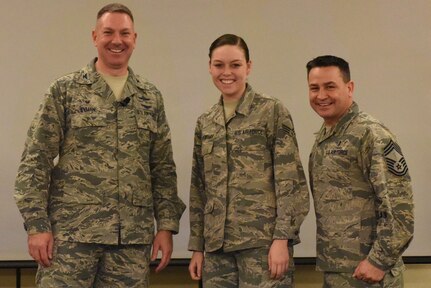 Senior Airman Allyson Walker-Cramer, center, 628th Civil Engineer Squadron engineer apprentice, is recognized by Col. Robert Lyman, left, 628th Air Base Wing commander, and Chief Master Sgt. Chad Ballance, right, 628th Medical Group superintendent, during a commander’s call at the Charleston Club Feb. 3, 2017. Walker-Cramer was awarded the coin for coaching youth athletics. (U.S. Air Force photo by Airman Joshua R. Maund)

