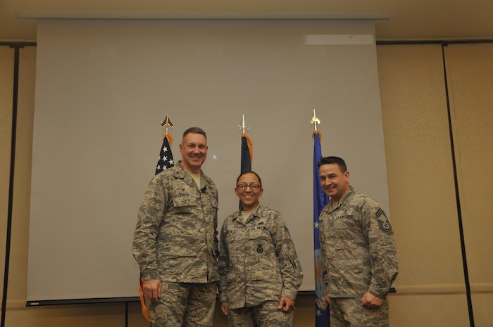 Senior Airman Mariah Smith, center, 628th Security Forces Squadron patrolman, is recognized by Col. Robert Lyman, left, 628th Air Base Wing commander, and Chief Master Sgt. Chad Ballance, right, 628th Medical Group superintendent, during a commander’s call at the Charleston Club Feb 3, 2017. Smith was coined for training 47 Airman and attending a principle of instruction course. 