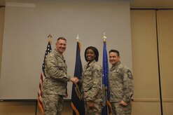 Staff Sgt. Amber Shepard, center, 628th Medical Group systems administrator, is recognized by Col. Robert Lyman, left, 628th Air Base Wing commander, and Chief Master Sgt. Chad Ballance, right, 628th Medical Group superintendent during a commander’s call at the Charleston Club Feb. 3, 2017. Sheppard was recognized for improving the production and security of her unit and her involvement with the local community. 