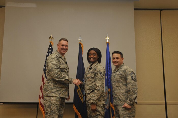 Staff Sgt. Amber Shepard, center, 628th Medical Group systems administrator, is recognized by Col. Robert Lyman, left, 628th Air Base Wing commander, and Chief Master Sgt. Chad Ballance, right, 628th Medical Group superintendent during a commander’s call at the Charleston Club Feb. 3, 2017. Sheppard was recognized for improving the production and security of her unit and her involvement with the local community. 
