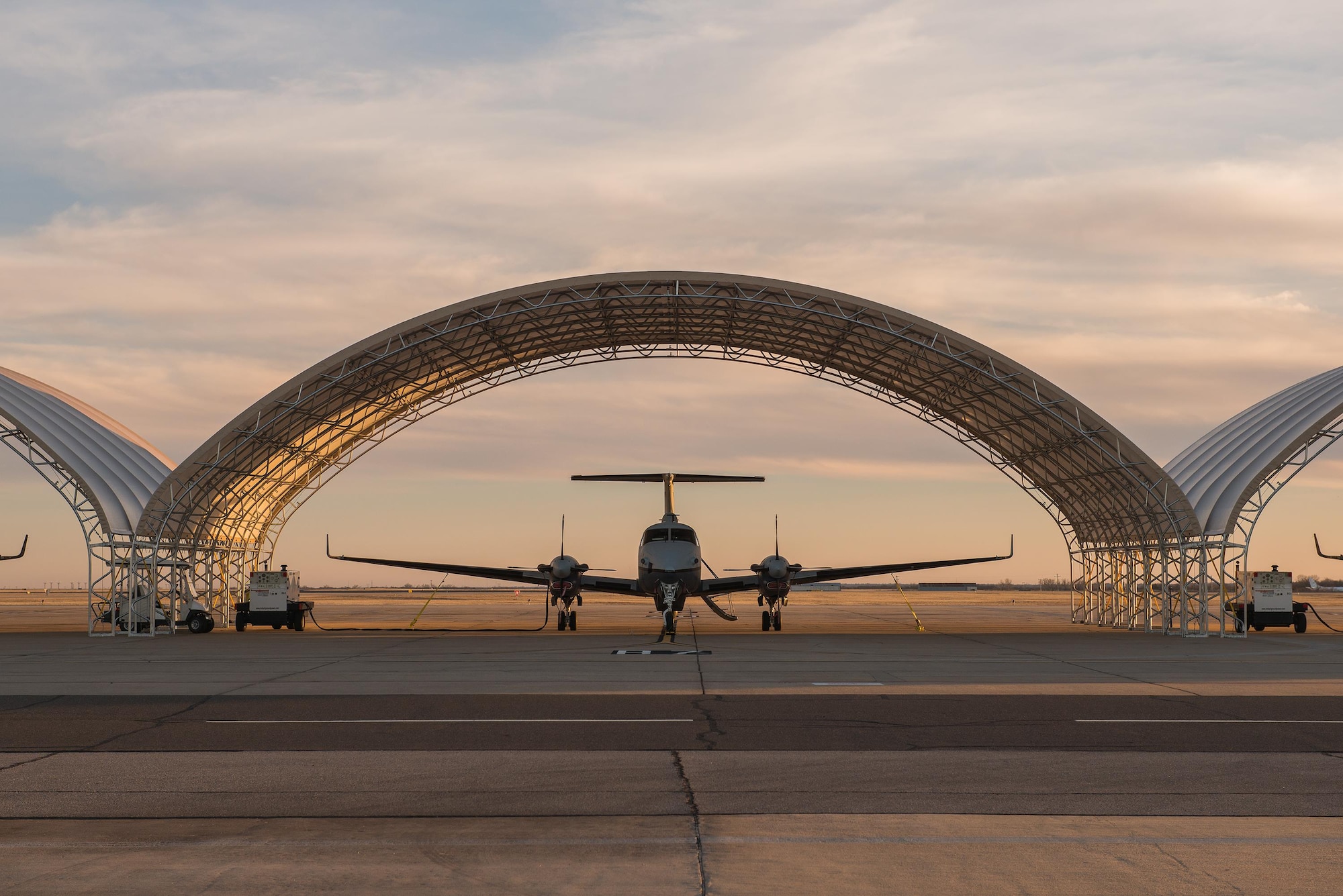 MC-12W's from the 137th Special Operations Wing, Oklahoma City, are parked under eight new aircraft shelters for the Will Rogers Air National Guard Base flight line, January 31, 2016. The shelters provide protection for the aircraft and the Airmen and contractors who work on them. (U.S. Air National Guard photo by Senior Master Sgt. Andrew M. LaMoreaux)