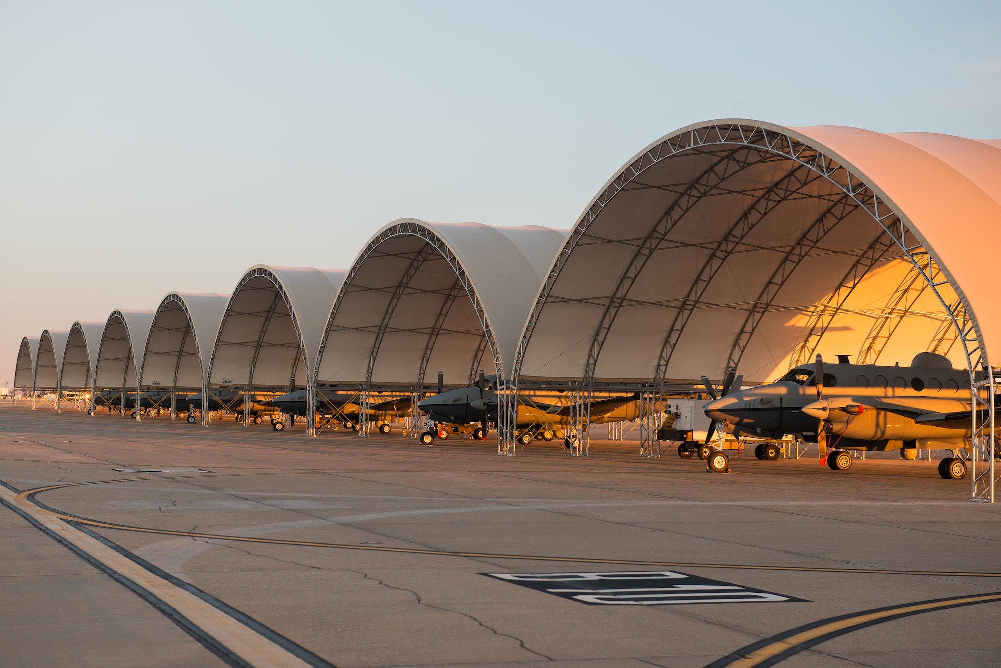 MC-12W's from the 137th Special Operations Wing, Oklahoma City, are parked under eight new aircraft shelters for the Will Rogers Air National Guard Base flight line, January 31, 2016. The shelters provide protection for the aircraft and the Airmen and contractors who work on them. (U.S. Air National Guard photo by Senior Master Sgt. Andrew M. LaMoreaux)