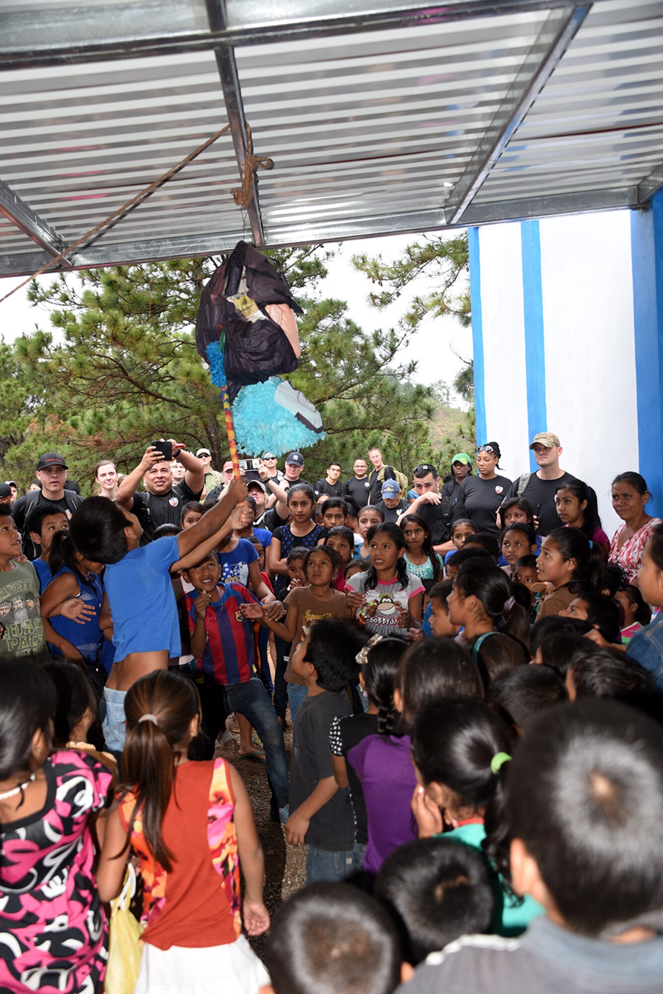 Children of the El Parasio village smack a piñata brought to them as part of Chapel Hike 71 Feb. 4. Members of Joint Task Force – Bravo participated in the hike just outside of Soto Cano Air Base to bring food and supplies to the underdeveloped village; and are also an opportunity to build partner relation capacity with a host nation. On most hikes, games and toys are brought along for the village kids to play with. 