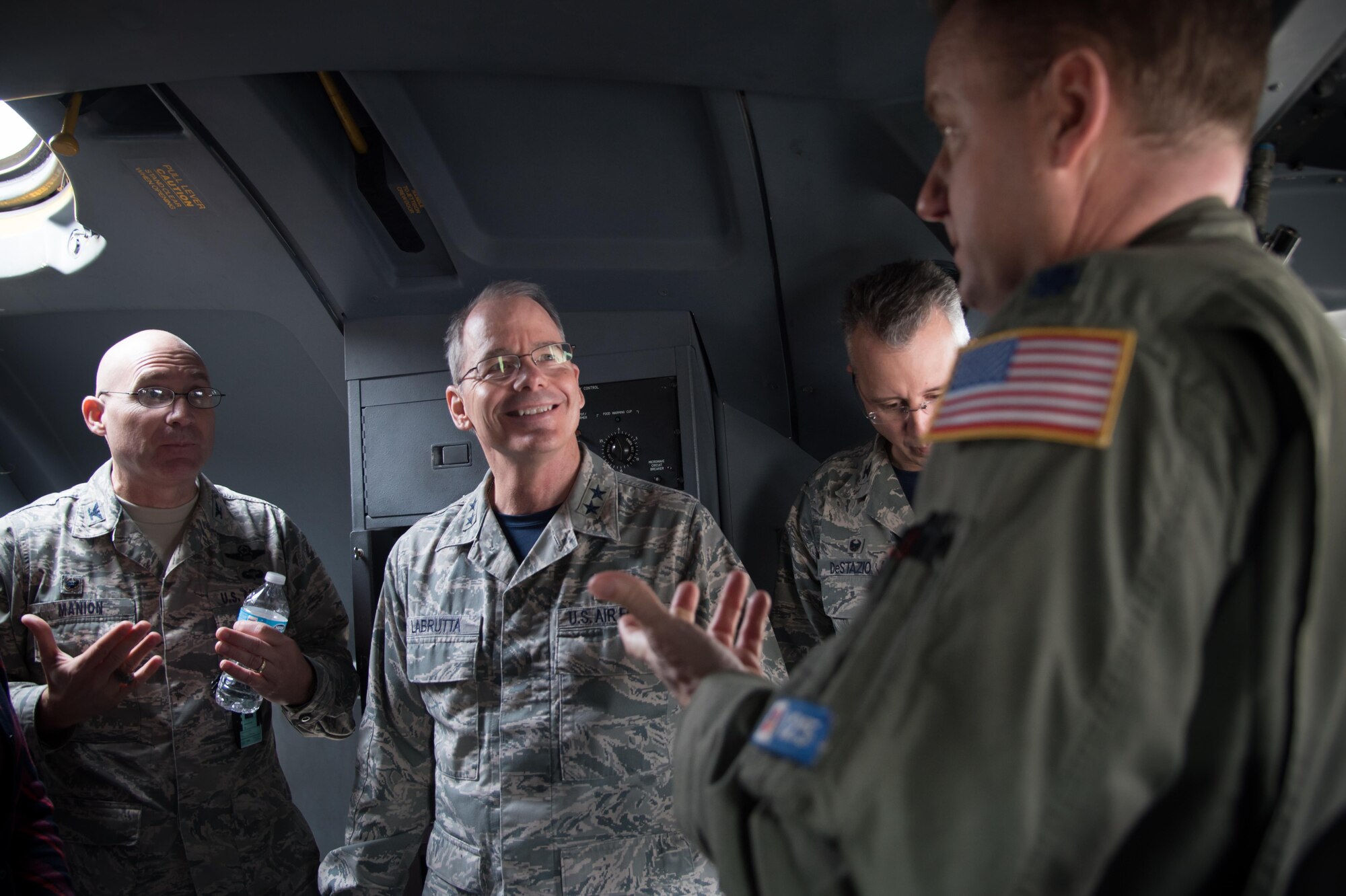 Lt. Col. Sean Cross, 53rd Weather Reconnaissance Squadron pilot, speaks with Col. Michael Manion, 403rd Wing commander, Maj. Gen. Robert LaBrutta, 2nd Air Force Commander, and Col. John DeStazio, Technical Training Operations Center commander, during a 403rd Wing immersion tour Feb. 3 at Keesler Air Force Base, Mississippi. (U.S. Air Force photo/Staff Sgt. Heather Heiney)