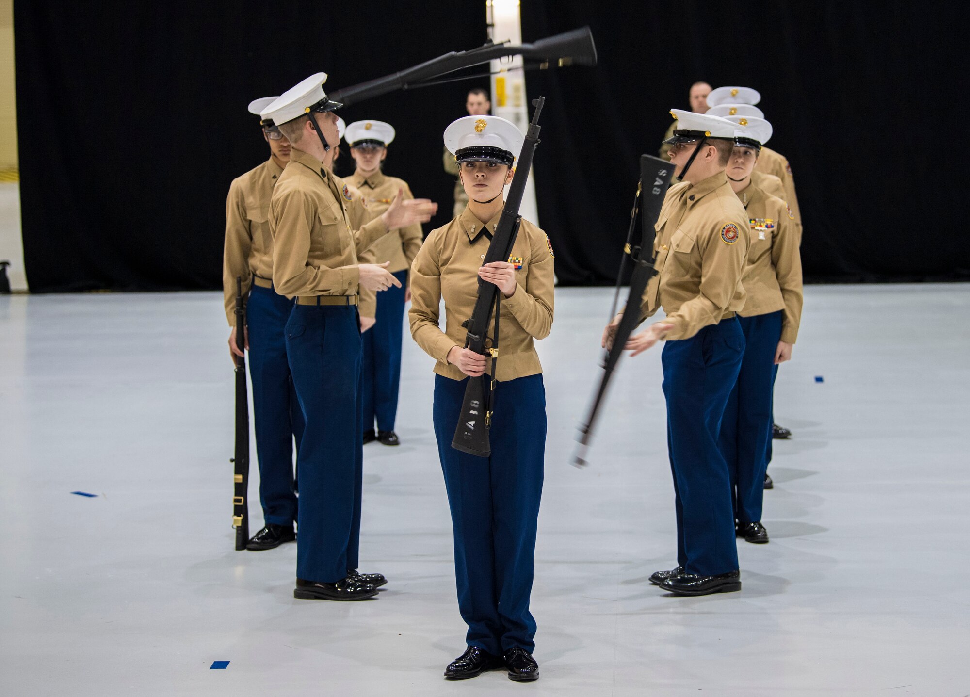 St. Albans High School students perform a rifle throw during the armed platoon exhibition portion of the West Virginia state Junior Reserve Officer Training Corps drill competition at McLaughlin Air National Guard Base, Charleston, W.Va.  Numerous high schools competed for the state title in events that included armed platoon exhibition, armed solo exhibition and overall drill team.  (U.S. Air National Guard photo by Tech. Sgt. De-Juan Haley)