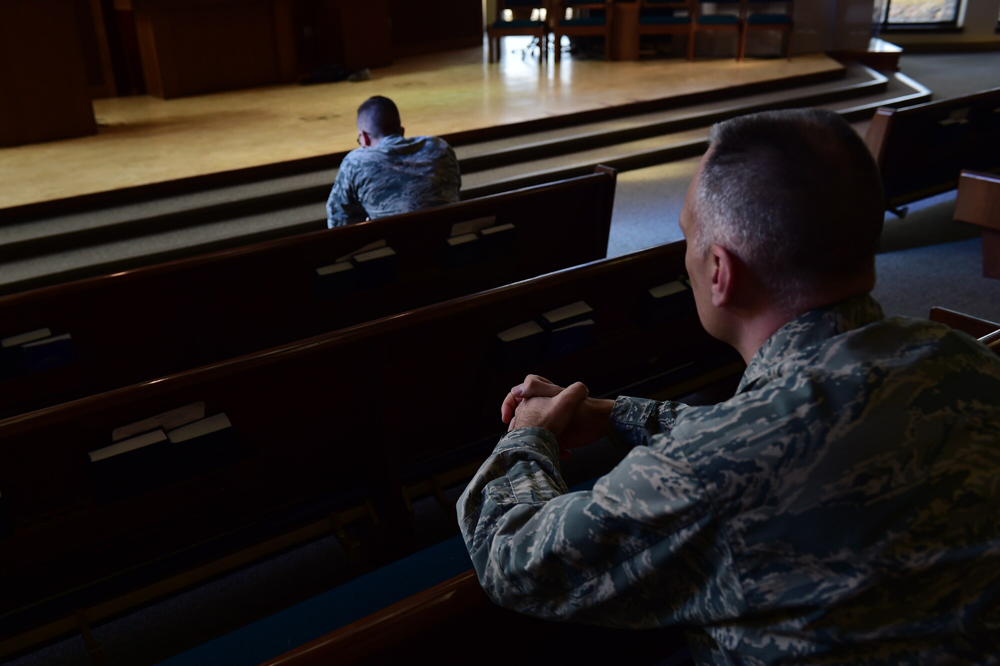 Chaplain (Maj.) Kevin Chelf, 460th Space Wing deputy wing chaplain, and Senior Airman Nicholas Pulkownik, 460th Operations Support Squadron staff instructor, take a moment of reflection Feb. 9, 2017, at the chapel on Buckley Air Force Base, Colo. The chapel is a spiritual outlet that focuses on the individual needs of each Airman. (U.S. Air Force photo by Airman 1st Class Gabrielle Spradling/Released)