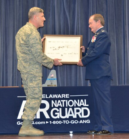 NEW CASTLE AIR NATIONAL GUARD BASE, Del.- Col. Robert Culcasi, commander, 166th Airlift Wing presents Col.Michael Feeley with a symbol of appreciation from the 166th Airlift Wing. The plaque includes imagery of Delaware Air National Guard C 130 aircraft, during a retirement ceremony held in honor of Feeley, on Dec. 4, 2016. (U.S. Air National Guard photo by Tech. Sgt. Gwendolyn Blakley/Released).