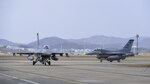 Two F-16 Fighting Falcons assigned to the 119th Fighter Squadron from the New Jersey Air National Guard taxi off of the runway at Osan Air Base, Republic of Korea, Feb. 9, 2017. Members of the 177th Fighter Wing deployed to Osan as part of a Theater Security Package to help bolster the strength of allied air forces on the Korea peninsula. 