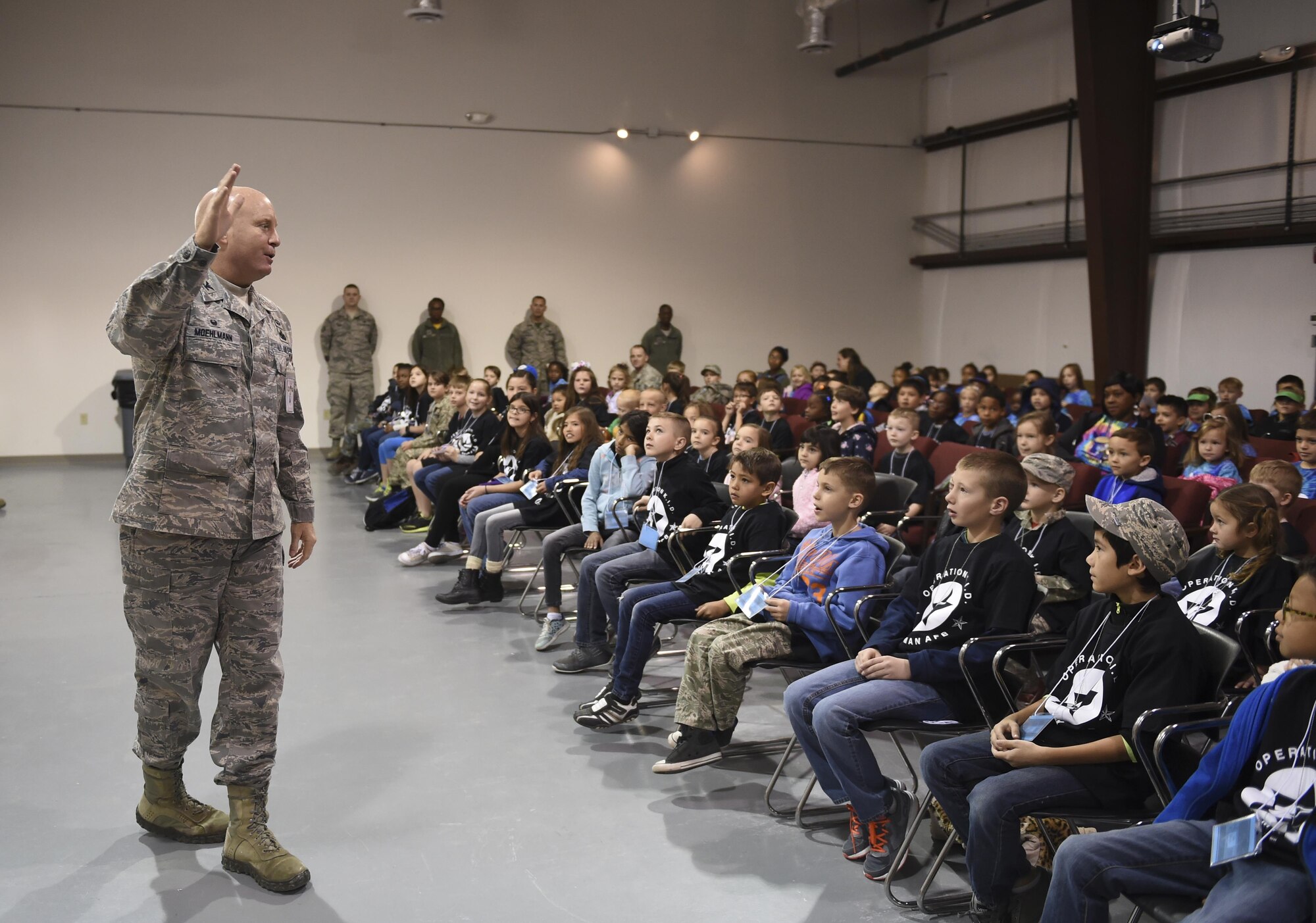 Colonel Joseph Moehlmann, the 635th Materiel Maintenance Group commander, briefs a group of children during Operation Kids Investigating Deployment at Holloman Air Force Base, N.M., Feb. 3, 2017. Operation KID is an annual event allowing children of military members to acquire a better understanding of what their parent goes through prior to a deployment. Military children were given a walk around the Basic Expeditionary Airfield Resources compound to see a mock deployment site, a mission brief, painted their faces, tried on Mission Oriented Protective Posture gear, and learn about different equipment including the opportunity to see a robot demonstration from Holloman’s Explosive Ordnance Disposal unit. (U.S. Air Force photo by Staff Sgt. Stacy Jonsgaard)