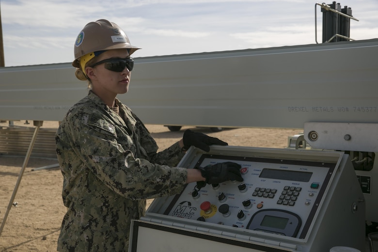 Petty Officer 3rd Class Laine Roman, main operator, Naval Mobile Construction Battalion 3, turns on the K-Span Machine to create the metal sheets used to create the K-Span units at Camp Wilson aboard the Marine Corps Air Ground Combat Center, Twentynine Palms, Calif., Feb. 2, 2017. NMCB 3 is in Camp Wilson for three weeks working on the construction of displacement walls and K-Span units for their upcoming deployment in April. (U.S. Marine Corps photo by Lance Cpl. Dave Flores)