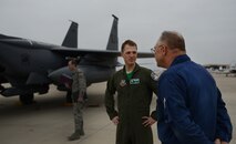 Capt. Michael Broyles, 335th Fighter Squadron weapons system officer (center), converses with his father, Ken Broyles (right), on Laughlin Air Force Base, Texas, Feb. 3, 2017. Broyles grew up on Laughlin during one of his father’s tours, and has returned as a weapons system officer on an F-15E. (U.S. Air Force photo/Airman 1st Class Benjamin N. Valmoja)