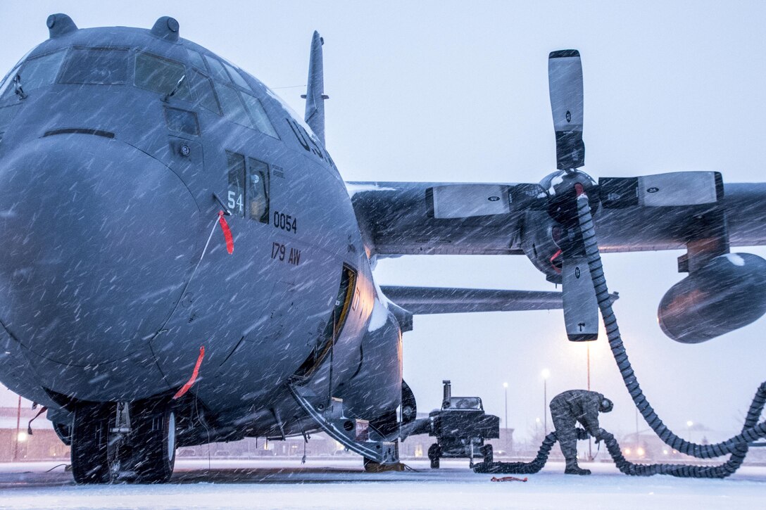 An airman preps a C-130H Hercules as a blanket of snow descends in Mansfield, Ohio., Feb. 9, 2017. The airman is assigned to the Ohio Air National Guard's 179th Airlift Wing. Air National Guard photo by 1st Lt. Paul Stennett
