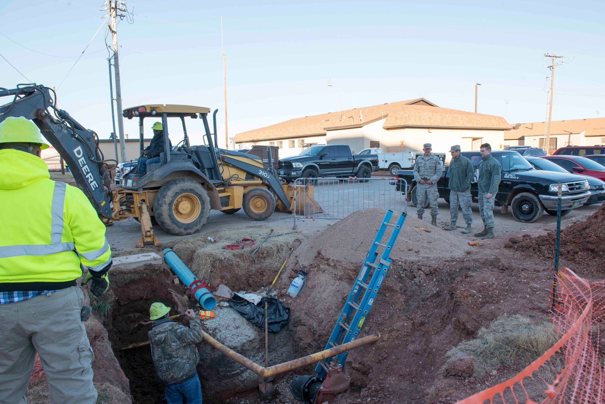 U.S. Air Force Airmen assigned to the 7th Civil Engineer Squadron oversee the removal of dirt from around a water pipe at Dyess Air Force Base, Texas, Jan. 31, 2017. The 7th CES has multiple projects on base—one of those is to install new water pipes to improve the quality of life for Dyess Airmen and families. (U.S. Air Force photo by Airman 1st Class Austin Mayfield)