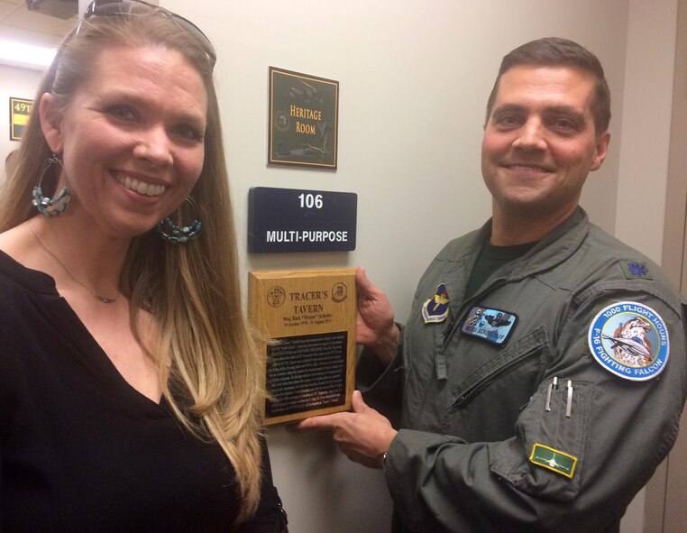 Lt. Col. David Bickerstaff, 49th Fighter Training Squadron Commander, hangs a plaque at the entrance of the 49th Fighter Training Squadron Heritage Room, renaming it to Tracer's Tavern Feb. 3, 2017, at Columbus Air Force base, Mississippi. The room was dedicated in honor and memory of Maj. Rick "Tracer" Shafer, a 49th FTS instructor pilot who lost his life during a general aviation accident on Aug. 31, 2014. The 49th FTS was joined by Ashley Shafer, Maj. Shafer’s widow, and their children. Additionally, the main briefing room at the 49th FTS was renamed in honor of Capt. Frank Mullinax Jr., 49th Fighter Interceptor Squadron World War II pilot who downed two German aircraft before being shot down, captured, spent nine months as a POW, escaped, spent nine months evading, was repatriated when the Allies took Italy and finally returned to U.S. soil July 4, 1944. (U.S. Air Force photo by Richard Johnson)