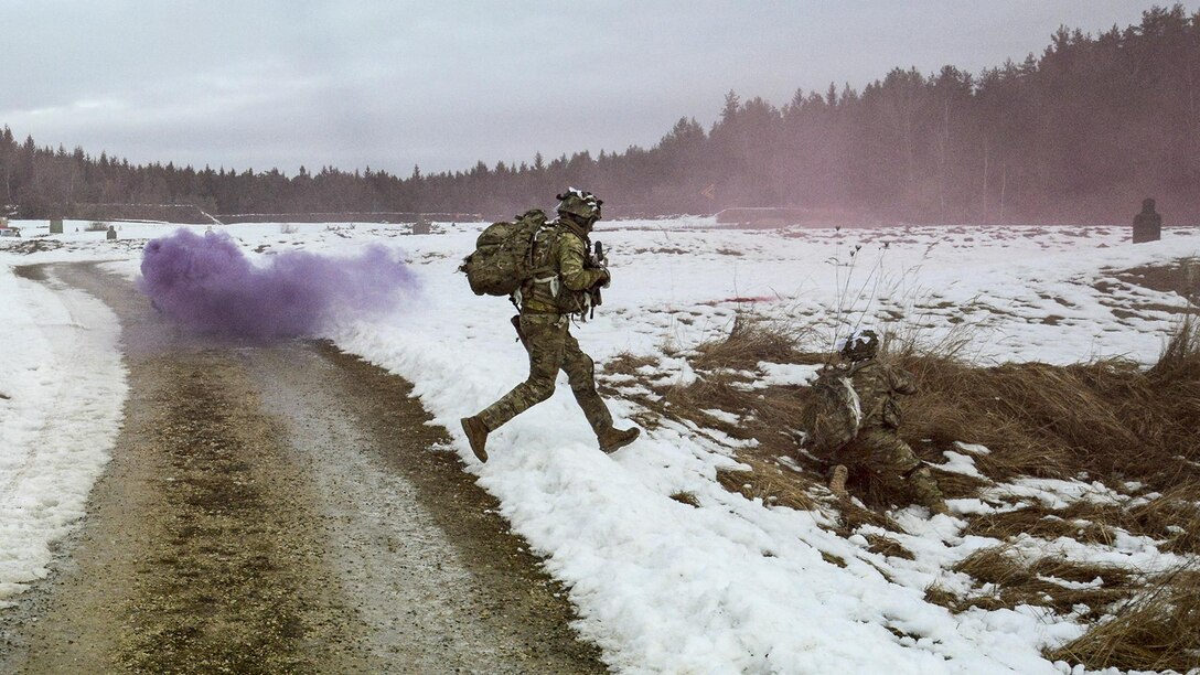 A soldier crosses a road under cover of smoke during a live-fire exercise at Grafenwoehr Training Area, Germany, Feb. 6, 2017. The soldier is a paratrooper assigned to 2nd Battalion, 503rd Infantry Regiment, 173rd Airborne Brigade. Army photo by Visual Information Specialist Matthias Fruth