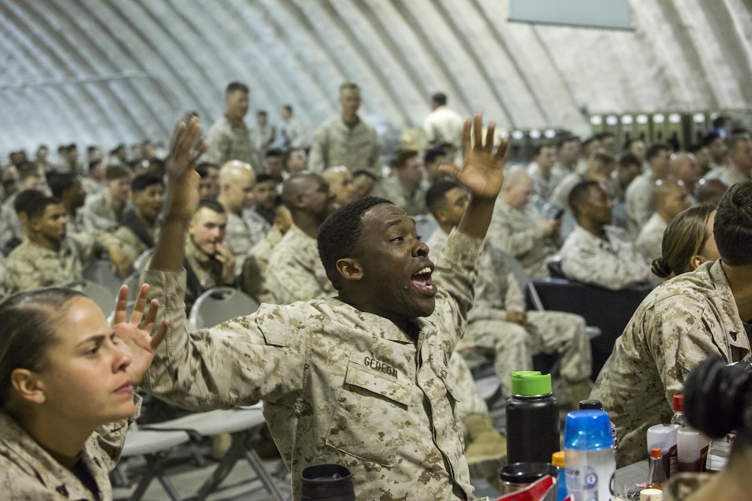 Cpl. Scott Gedeon, food service specialist, 1st Marine Logistics Group, cheers on his favorite team during the Palm Springs Bob Hope USO hosted showing of Super Bowl LI at the dining facility at Camp Wilson aboard Marine Corps Air Ground Combat Center, Twentynine Palms, Calif., Feb. 5, 2017. (U.S. Marine Corps photo by Cpl. Levi Schultz)
