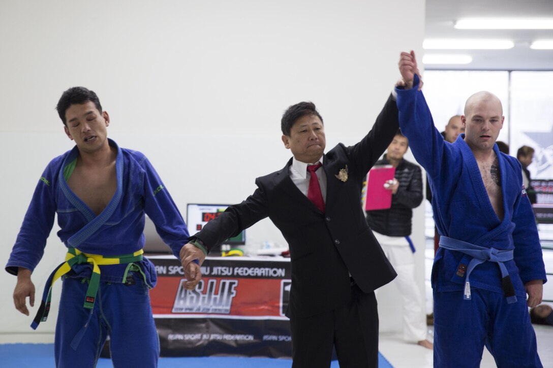 U.S. Marine Corps Lance Cpl. Keegan Cell, an air framer with Marine Aviation Logistics Squadron (MALS) 12, right, gets his hand raised after defeating his opponent during the Duamau Tournament, a jiu jitsu competition at the TK Training Center in Hiroshima, Japan, Feb. 5, 2017. Jiu jitsu is an art of weaponless fighting which employs holds and throws to subdue or disable an opponent. Hinckley trains among other Marines at the Iron Works North gym on Marine Corps Air Station Iwakuni. (U.S. Marine Corps photo by Lance Cpl. Joseph Abrego)