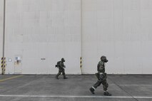 (Right to left) Senior Airman Britt Odom and Senior Airmen Collin Eddington, both from the 374th Maintenance Squadron ISO aerospace maintenance apprentices, perform a simulated Post Attack Reconnaissance (PAR) sweep during the Wartime Readiness Inspection at Yokota Air Base, Japan, Feb. 8, 2017. The inspection was designed to evaluate Yokota’s ability to provide airlift capabilities while responding to a variety of real-world scenarios. (U.S. Air Force photo by Yasuo Osakabe/Released)