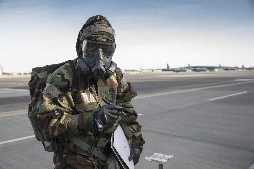 Senior Airman Collin Eddington, 374th Maintenance Squadron ISO aerospace maintenance apprentice, writes the date and time on a simulated M8 Chemical Agent Detection Paper during the Wartime Readiness Inspection at Yokota Air Base, Japan, Feb. 8, 2017. The inspection was designed to evaluate Yokota’s ability to provide airlift capabilities while responding to a variety of real-world scenarios. (U.S. Air Force photo by Yasuo Osakabe/Released)