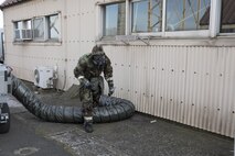 Senior Airman Britt Odom, 374th Maintenance Squadron ISO aerospace maintenance apprentice, searches for a simulated suspicious and hazardous materials around a building as a Post Attack Reconnaissance (PAR) sweep team, during the Wartime Readiness Inspection at Yokota Air Base, Japan, Feb. 8, 2017. The inspection was designed to evaluate Yokota’s ability to provide airlift capabilities while responding to a variety of real-world scenarios. (U.S. Air Force photo by Yasuo Osakabe/Released)