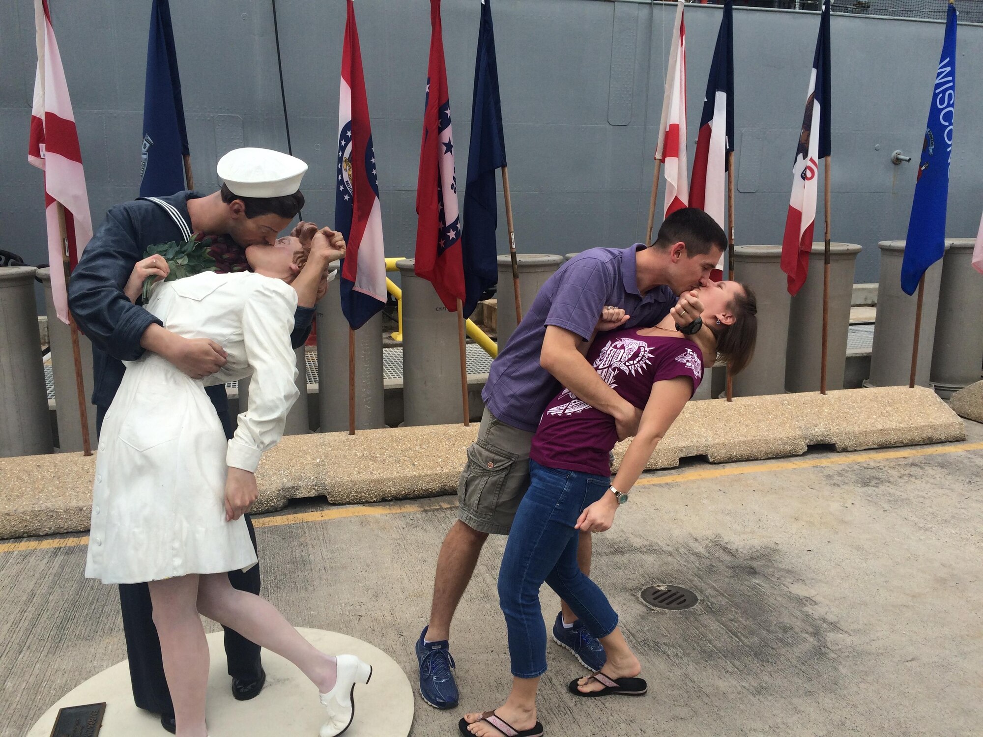 U.S. Air Force Maj. Josh Daniels, Deputy Director of Operations, Air Force Public Affairs Agency, Joint Base San Antonio-Randolph, Texas, and his wife Shellie, duplicate the iconic Times Square victory kiss at Pearl Harbor, Hawaii, Jan. 11, 2016. This victory moment symbolized the victory that Shellie would soon achieve over the cancer. (Courtesy photo)