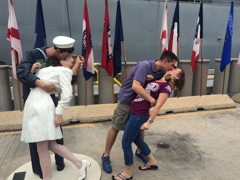 U.S. Air Force Maj. Josh Daniels, Deputy Director of Operations, Air Force Public Affairs Agency, Joint Base San Antonio-Randolph, Texas, and his wife Shellie, duplicate the iconic Times Square victory kiss at Pearl Harbor, Hawaii, Jan. 11, 2016. This victory moment symbolized the victory that Shellie would soon achieve over the cancer. (Courtesy photo)