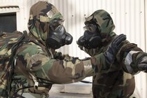 Senior Airman Collin Eddington, 374th Maintenance Squadron ISO aerospace maintenance apprentice, left, simulates decontaminating Senior Airman Britt Odom, 374th MXS ISO aerospace maintenance apprentice, during the Wartime Readiness Inspection at Yokota Air Base, Japan, Feb. 8, 2017. The inspection was designed to evaluate Yokota’s ability to provide airlift capabilities while responding to a variety of real-world scenarios. (U.S. Air Force photo by Yasuo Osakabe/Released)