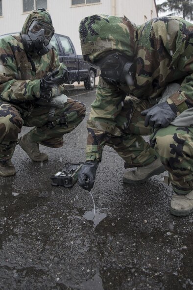 (Right and left) Airman 1st Class Julius Dinkins, 374th Aerospace Medicine Squadron, bioenvironmental engineering journeyman, and Capt. Gregory Arrington, 374th AMDS bioenvironmental engineering flight chief, perform detecting simulated sample of chemical agents by HazMatID Elite at Yokota Air Base, Japan, Feb. 9, 2017, during the Wartime Readiness Inspection. The inspection was designed to evaluate Yokota’s ability to provide airlift capabilities while responding to a variety of real-world scenarios. (U.S. Air Force photo by Yasuo Osakabe/Released)    