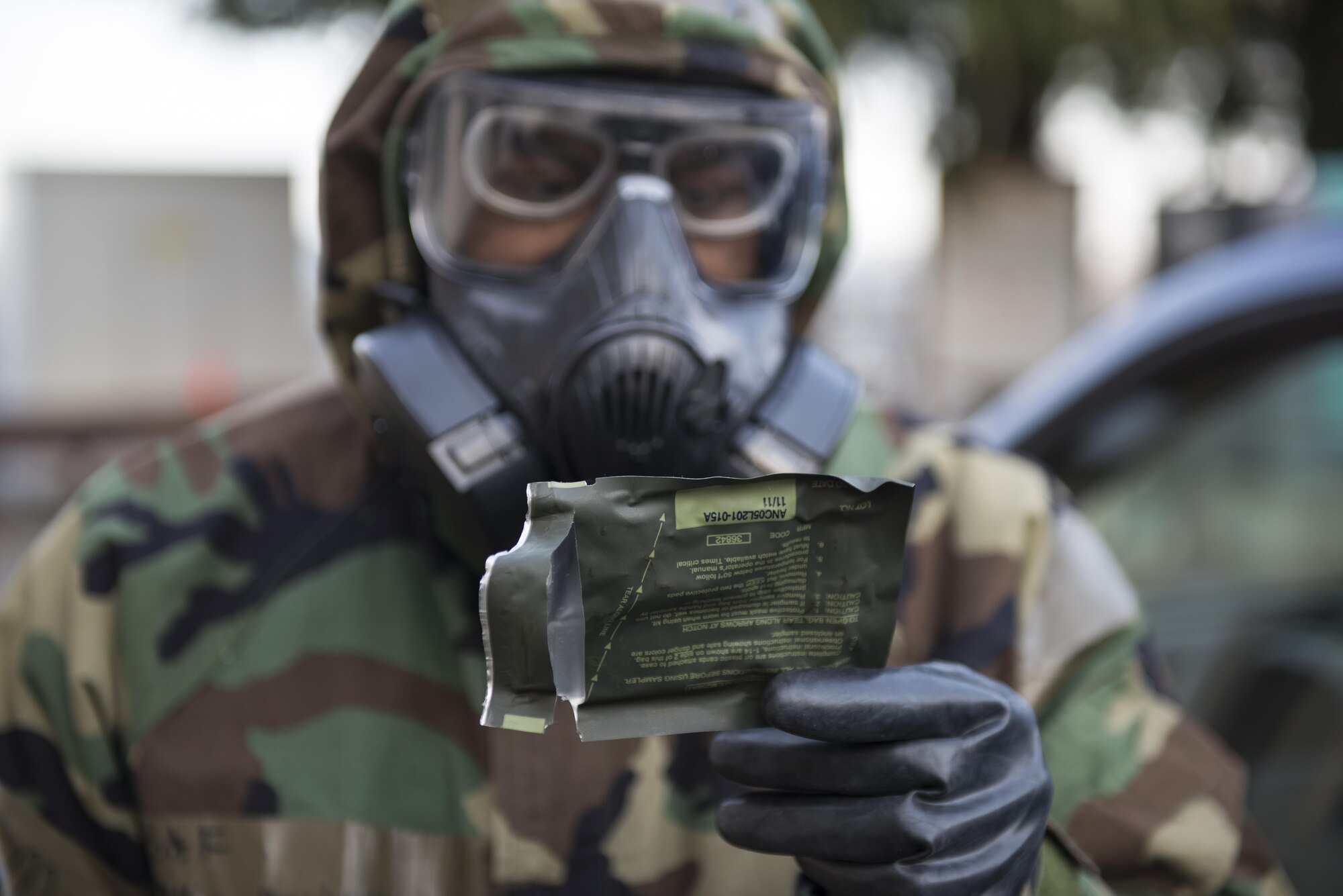 Airman 1st Class Julius Dinkins, 374th Aerospace Medicine Squadron bioenvironmental engineering journeyman, reads the instructions of a test prior to taking a sample Feb. 8, 2017, at Yokota Air Base, Japan. During the inspection, Yokota's airlift capabilities were tested in a variety of real-world scenarios. (U.S. Air Force photo by Airman 1st Class Juan Torres)