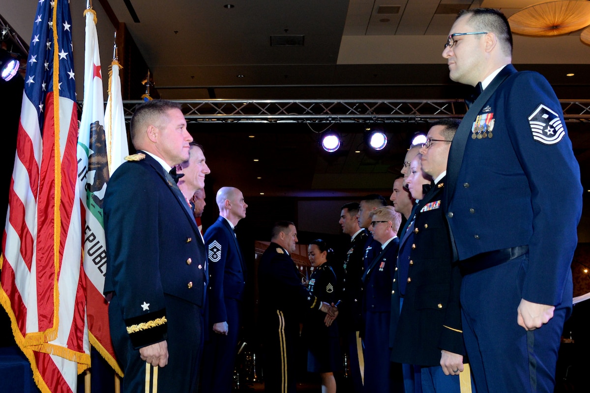 Winners of this year's Outstanding Soldier/Airman of the Year competition stand at attention as California's Adjutant General Major General David Baldwin congratulates each member individually. 146th Airlift Wing's Master Sgt. Josh Baker stands front right and received the award in the First Sergeant category. (U.S. ANG photo by: Staff Sgt. Kim Ramirez)