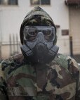 Airman 1st Class Julius Dinkins, 374th Aerospace Medicine Squadron bioenvironmental engineering journeyman, wears a Mission Oriented Protective Posture (MOPP) gear during the Wartime Readiness Inspection at Yokota Air Base, Japan, Feb. 9, 2017. Dinkins performed a simulated biological tests using a HASMAT ID for qualitative material analysis, and a MultiRae, multi-gas monitor for confined space applications. (U.S. Air Force photo by Yasuo Osakabe/Released)