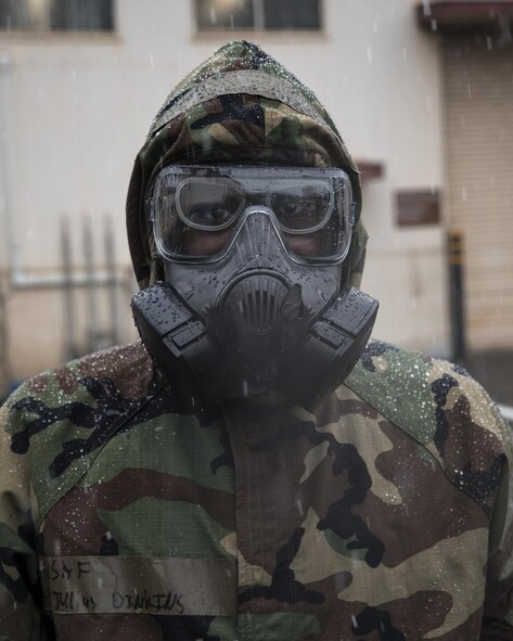 Airman 1st Class Julius Dinkins, 374th Aerospace Medicine Squadron bioenvironmental engineering journeyman, wears a Mission Oriented Protective Posture (MOPP) gear during the Wartime Readiness Inspection at Yokota Air Base, Japan, Feb. 9, 2017. Dinkins performed a simulated biological tests using a HASMAT ID for qualitative material analysis, and a MultiRae, multi-gas monitor for confined space applications. (U.S. Air Force photo by Yasuo Osakabe/Released)