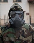 Airman 1st Class Julius Dinkins, 374th Aerospace Medicine Squadron bioenvironmental engineering journeyman, wears a Mission Oriented Protective Posture (MOPP) gear during the Wartime Readiness Inspection at Yokota Air Base, Japan, Feb. 9, 2017. Dinkins performed a simulated biological tests using a HASMAT ID for qualitative material analysis, and a MultiRae, multi-gas monitor for confined space applications. (U.S. Air Force photo by Yasuo Osakabe/Released)