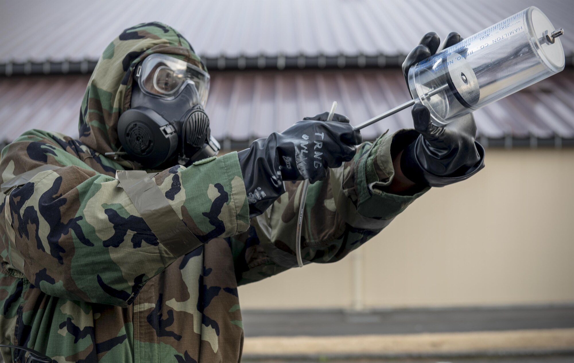 Capt. Gregory Arrington, 374th Aerospace Medicine Squadron bioenvironmental engineering flight chief, takes an air sample for testing during a Wartime Readiness Inspection Feb. 8, 2017, at Yokota Air Base, Japan. During the inspection, Yokota's airlift capabilities were tested in a variety of real-world scenarios. (U.S. Air Force photo by Airman 1st Class Juan Torres)