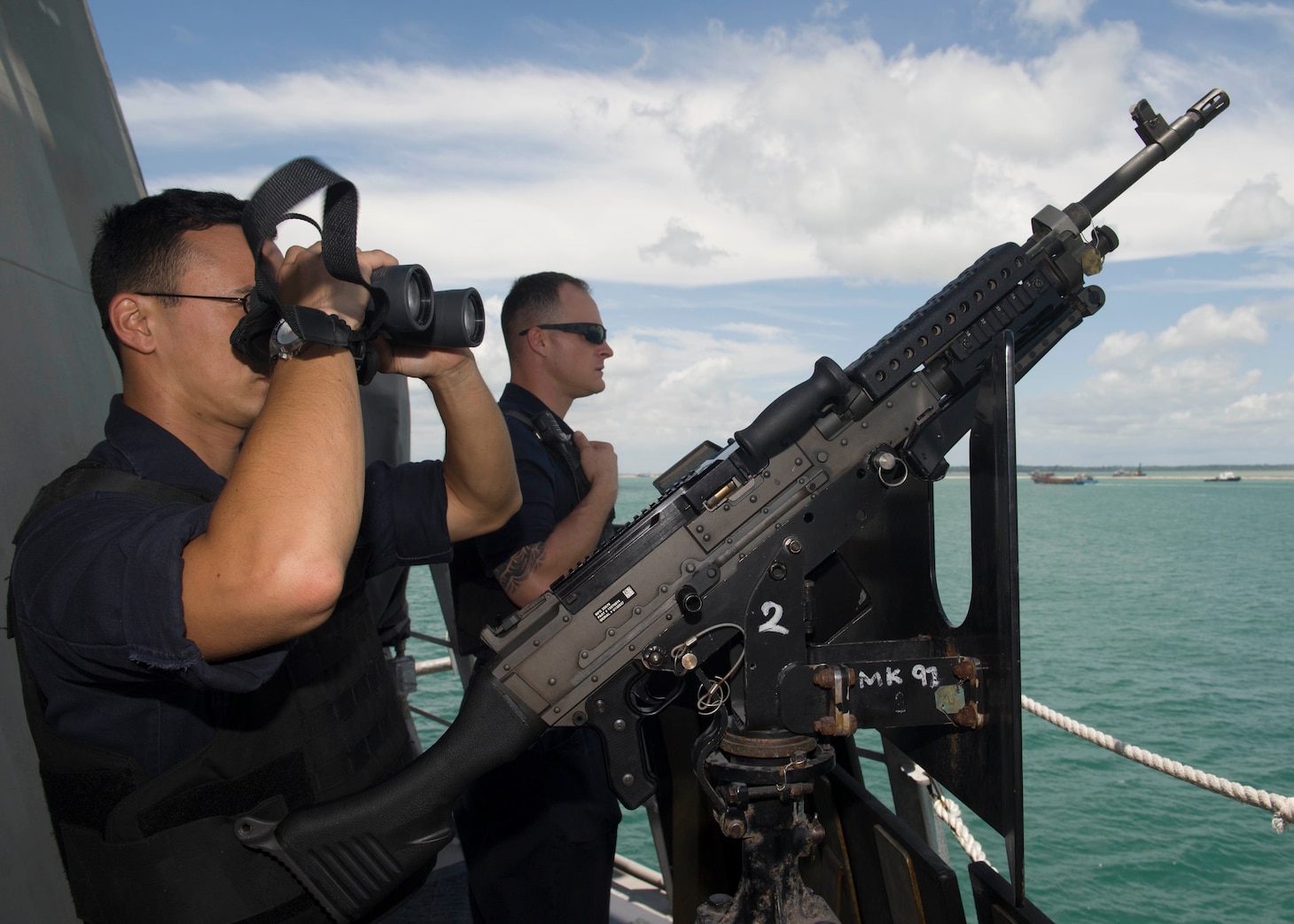 SEMBAWANG NAVAL BASE, Singapore (Feb. 03, 2017) Gunner's Mate 1st Class Galo Hernandez, left, and Gunner's Mate 1st Class Benjamin Greene stand watch as littoral combat ship USS Coronado (LCS 4) prepares to pull into port. 