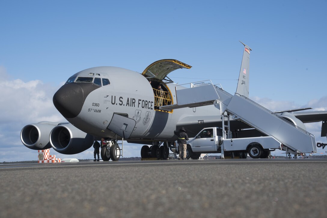 U.S. Air Force Airmen work with the 730th Air Mobility Squadron Operating Location Bravo air terminal ground handling services civilian contractors to connect loading stairs to a KC-135 Stratotanker assigned to the 733rd AMS out of Kadena Air Base, Japan, at Misawa Air Base, Japan, Jan. 19, 2017. The 730th AMS terminal works with contractors and provides support during medical evacuations. The aircraft landed at Misawa to retrieve a patient. (U.S. Air Force photo by Airman 1st Class Sadie Colbert)