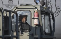 U.S. Air Force civilian contractor, Spencer Flippings, a 730th Air Mobility Squadron airfreight technician, watches his path as he backs up a Tunner 60K-loader at Misawa Air Base, Japan, Jan. 19, 2017. The loader is used for transporting cargo up to 60,000 pounds into an aircraft. (U.S. Air Force photo by Airman 1st Class Sadie Colbert)