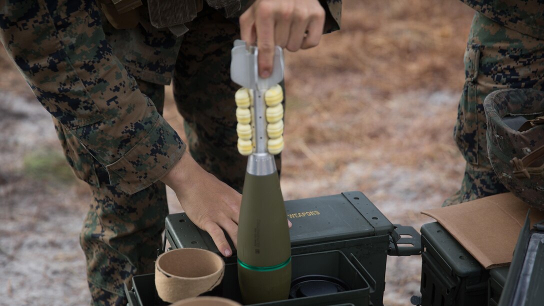 A Marine with Weapons Co., 2nd Battalion, 6th Marine Regiment, removes an M821A2 High Explosive mortar round from its casing before prepping the round to fire at Camp Lejeune, N.C., Feb. 8, 2017. The Marines fired off red phosphorous and high explosive rounds during a training exercise where they were able to coordinate with Expeditionary Warfare Training Group Atlantic during their qualification training for Joint Terminal Attack Controllers.
