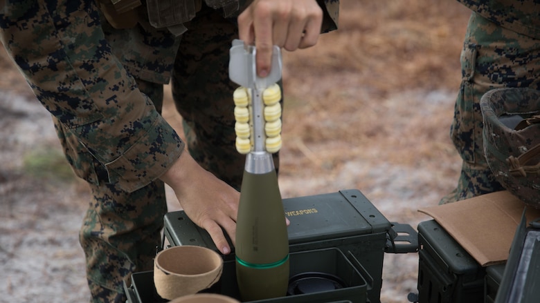 A Marine with Weapons Co., 2nd Battalion, 6th Marine Regiment, removes an M821A2 High Explosive mortar round from its casing before prepping the round to fire at Camp Lejeune, N.C., Feb. 8, 2017. The Marines fired off red phosphorous and high explosive rounds during a training exercise where they were able to coordinate with Expeditionary Warfare Training Group Atlantic during their qualification training for Joint Terminal Attack Controllers.