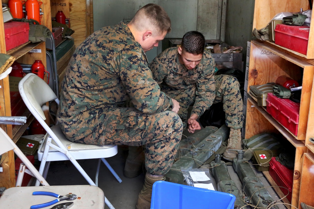 Sgt. Ryan Tugas, right, assists Cpl. Taylor Bolduc with stripping a wire during an inspection aboard Marine Corps Air Station Cherry Point, N.C., Jan. 31, 2017. “At 22 years old, how many other opportunities would someone my age usually have for a meaningful, lasting impact on people’s lives,” said Tugas, a is a motor transport operator assigned to Marine Tactical Air Command Squadron 28, Marine Air Control Group 28, 2nd Marine Aircraft Wing. Bolduc is also a motor transport operator with MTACS-28. (U.S. Marine Corps photo by Cpl. Jason Jimenez/ Released)