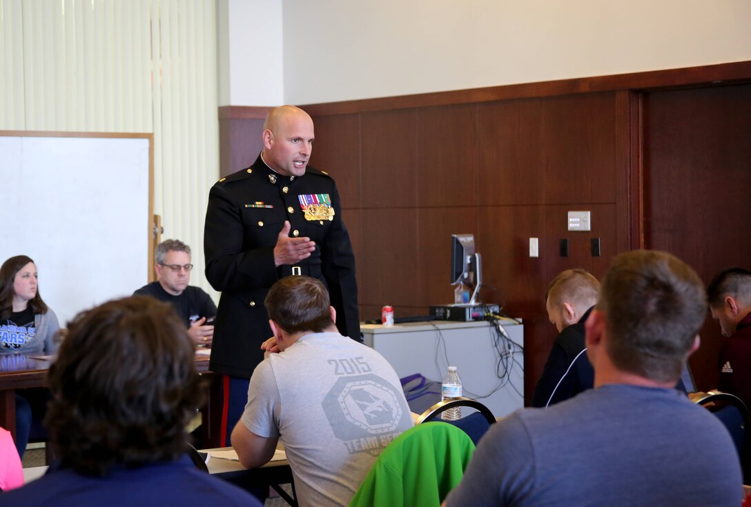 Major Ryan Cohen speaks with mentors and coaches ahead of the Women's Collegiate Wrestling Association Championship event in Oklahoma City. The Marines intend to show the wrestlers, coaches and mentors that their fighting spirit is much like our own. Cohen is the Commanding Officer for Recruiting Station Oklahoma City. The pre-tournament occurred on Feb. 9, and the tournament is scheduled for Feb. 10-11. 