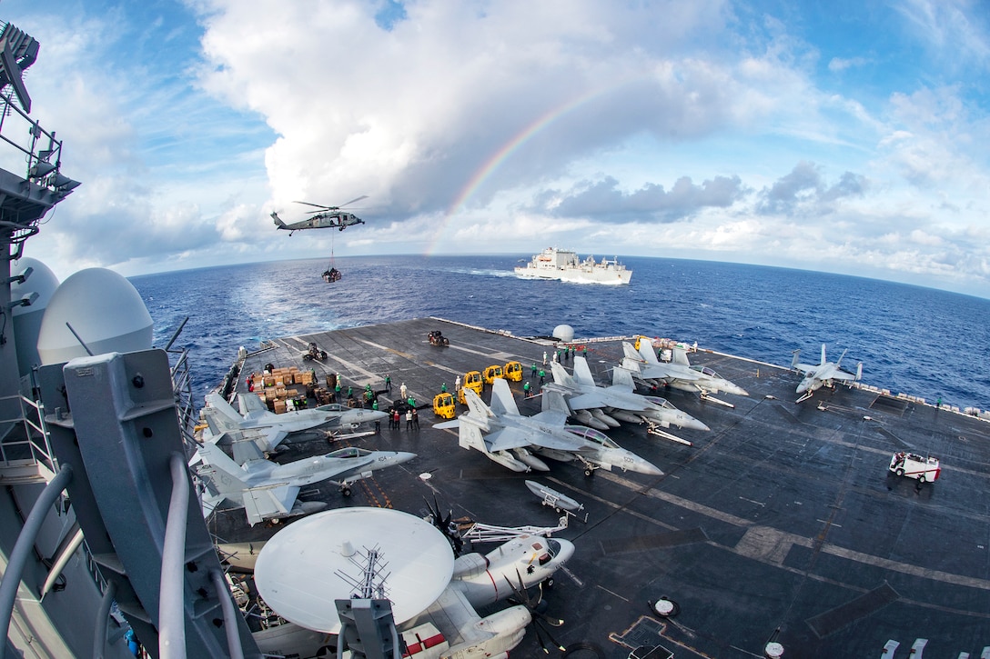 A Navy MH-60S Seahawk helicopter delivers supplies to the aircraft carrier USS Carl Vinson during a vertical replenishment with the dry cargo and ammunition ship USNS Charles Drew in the Pacific Ocean, Feb. 3, 2017. Navy photo by Petty Officer 2nd Class Sean M. Castellano 