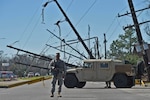 Louisiana National Guard Staff Sgt. Casey Delcambre, 2nd Battalion, 156th Infantry Regiment, 256th Infantry Brigade Combat Team, directs traffic at a static traffic control points in New Orleans East, Feb. 10, 2017. The Guardsmen are working in support of local, parish and state emergency officials after severe thunderstorms spawned several tornadoes in southeast Louisiana. 
