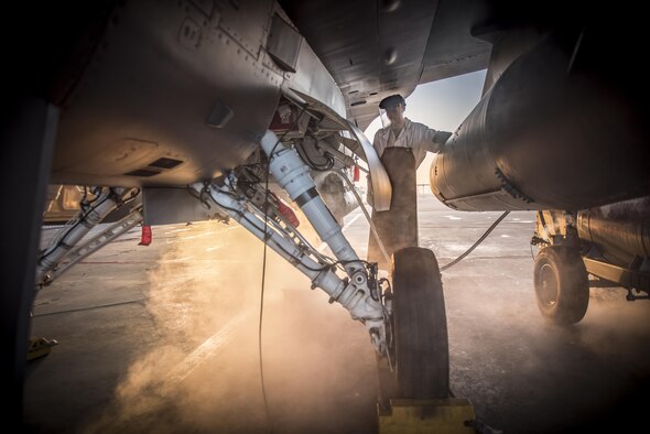 Senior Airman Austin Boyd, of the 138th Fighter Wing, attaches a hose containing liquid oxygen to an F-16 Fighting Falcon, Feb. 1, 2017. (U.S. Air National Guard photo/Tech. Sgt. Drew A. Egnoske)