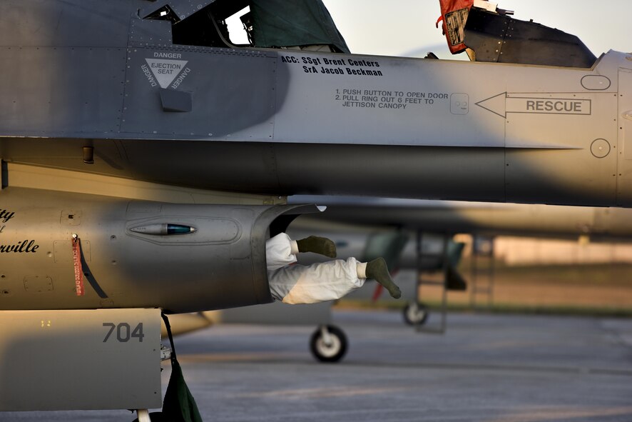 An F-16 Fighting Falcon crew chief assigned to Ohio Air National Guard’s 180th Fighter Wing squeezes into the intake of on an F-16 during a preflight inspection at MacDill Air Force Base, Fla., Feb. 2, 2017. The 180th FW brought their F-16s and about 150 maintainers, pilots, and operations specialists to MacDill AFB for a two-week training exercise. (U.S. Air National Guard photo/Tech. Sgt. Nic Kuetemeyer)