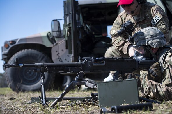 Airman 1st Class Jesse Kassed, a 822nd Base Defense Squadron fireteam member, fires an M240B machine gun at fixed targets down range Feb. 3, 2017, at Moody Air Force Base, Ga. A bipod holds the M240B as Kassed aims and fires 800 rounds at fixed targets while wearing a gas mask. (U.S. Air Force photo/Airman 1st Class Janiqua P. Robinson)